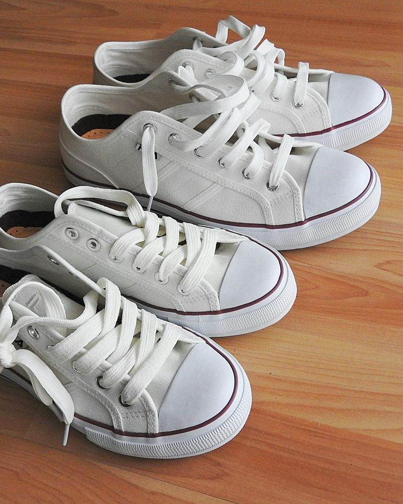 Close up of athletic shoes and a clean wooden floor